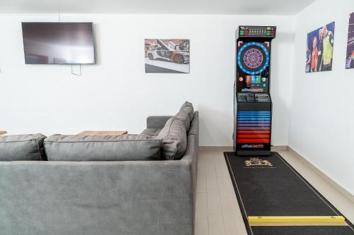 a living room with a couch and a clock on the wall at Land-gut-Hotel am Ring in Meuspath