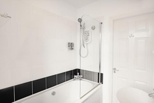 a bathroom with a bath tub and a shower at The Town House in Douglas