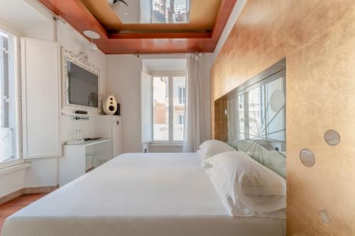 a bedroom with a large white bed and a window at Hotel Trecento in Rome