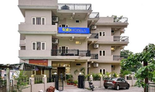 a large white building with a sign on it at FabExpress Central Park in Dehradun