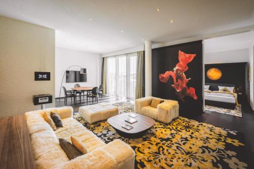 a large living room with two couches and a table at Kameha Grand Bonn in Bonn