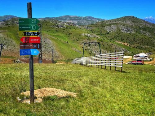 a sign on the side of a hill with a fence at Hotel Fersped in Mavrovo