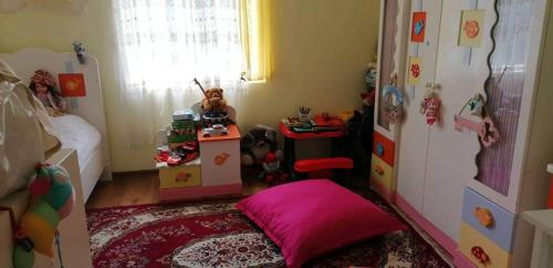 a childs bedroom with a pink bed and a small room at Special Guest House in Guria in Chala
