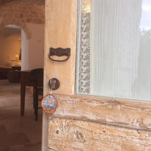 a wooden door with a lock on a window at Trullidea in Alberobello