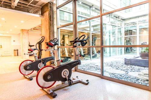 a gym with two exercise bikes in front of a window at Hotel Kabuki, part of JdV by Hyatt in San Francisco