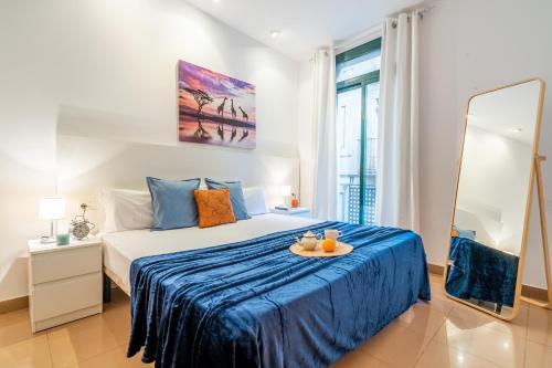 a bedroom with a bed with a tray of fruit on it at Lodging Apartments Liceu G2 in Barcelona
