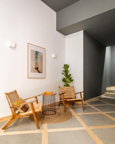 a living room with two chairs and a table at BYPILLOW La Sal in Cádiz