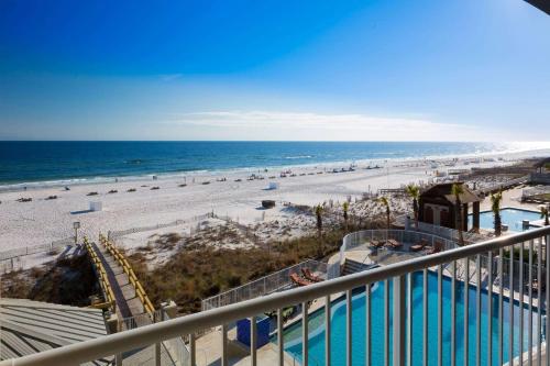 a view of the beach from the balcony of a condo at Escapes! To The Shores Orange Beach, A Ramada by Wyndham in Orange Beach