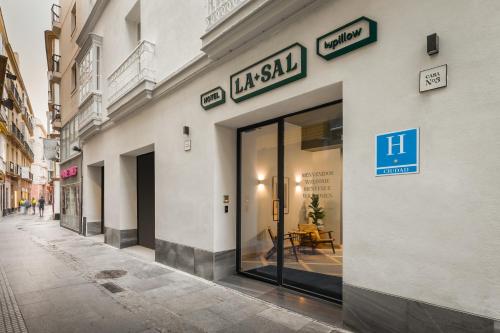 a store front with glass doors on a street at BYPILLOW La Sal in Cádiz