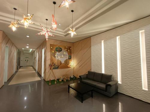 a living room with a couch and a chandelier at Eve Suite in Petaling Jaya