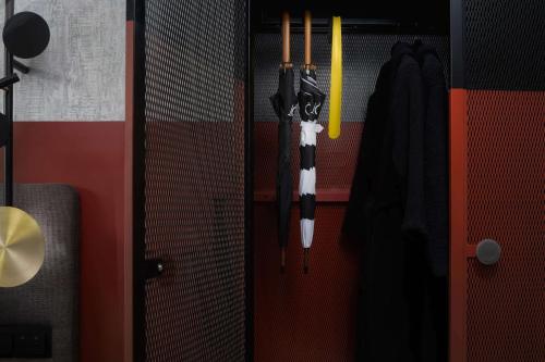 a door with two umbrellas hanging on a wall at QT Auckland in Auckland