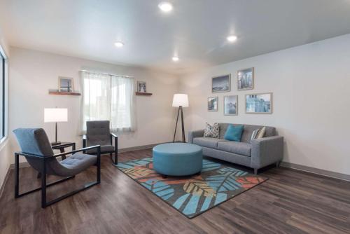 a living room with a couch and a chair at WoodSpring Suites Philadelphia Northeast in Philadelphia