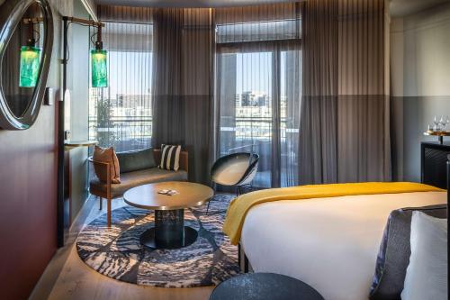 a hotel room with a bed and a couch at QT Auckland in Auckland