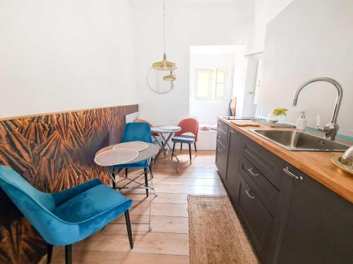 a kitchen with a table and chairs and a sink at Via Vittoria Quattro in Rome