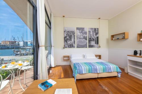 a hotel room with a bed and a balcony at Locanda da Toto in Genova