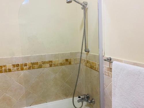 a shower with a glass door in a bathroom at Ocean View Villas F05 in Port Edward