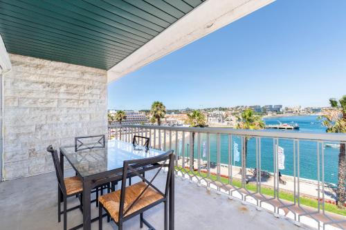 a balcony with a table and chairs and a view of the water at Cascais Bay Terrace iv in Cascais