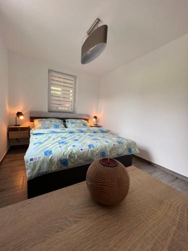 a bedroom with a bed and a bowl on the floor at Apartmán Nad Úpou in Pec pod Sněžkou