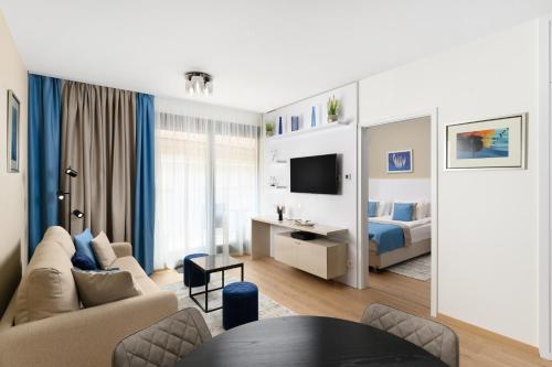 a living room with a couch and a bed at Emerald Downtown Luxury Suites by Continental Group in Budapest
