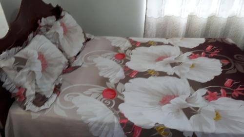 a bed with white flowers on top of it at Toofan villa in Flic-en-Flac