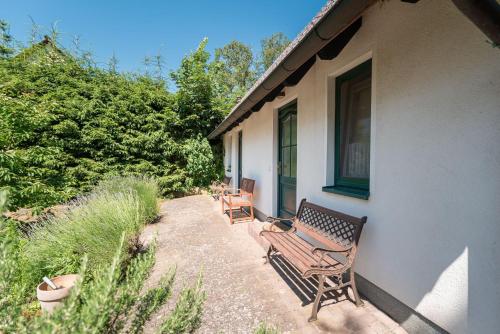 three benches sitting on the side of a house at Haus Selene in Neu Sallenthin