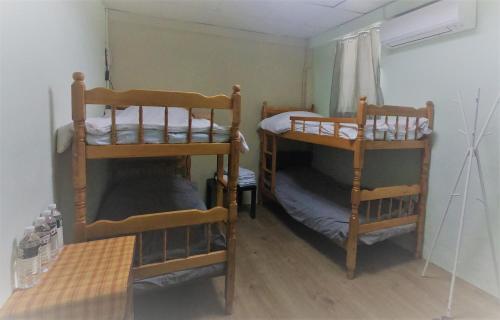 a room with two bunk beds in a room at Together Stay in Juguang