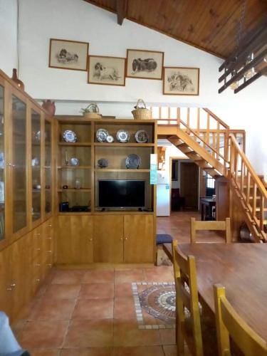 a living room with a staircase and a television at Alojamento Local Madre de Cima in Vinhais
