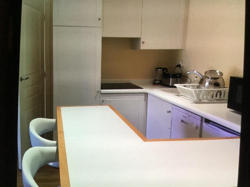 a kitchen with a table and a counter top at 2p sur le golf de La Baule 