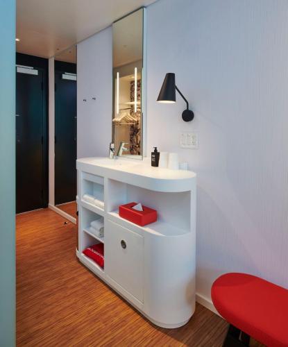 a bathroom with a white sink and a mirror at citizenM Washington DC NoMa in Washington