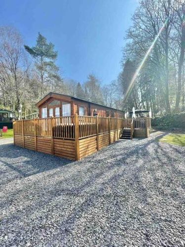 a small playground with a train in a park at Hartland Lodge - White Cross Bay Holiday Park in Windermere