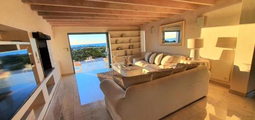 a living room with a couch and a television at Nieuview Cottages 1 and 2 in Paternoster