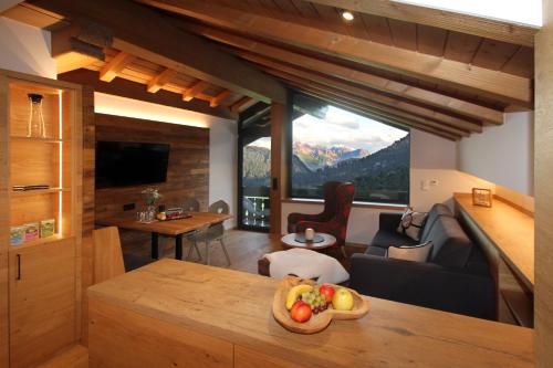 a kitchen and living room with a view of a mountain at Bergzauber Alpin Suites - Skipiste - Private Sauna in Bolsterlang