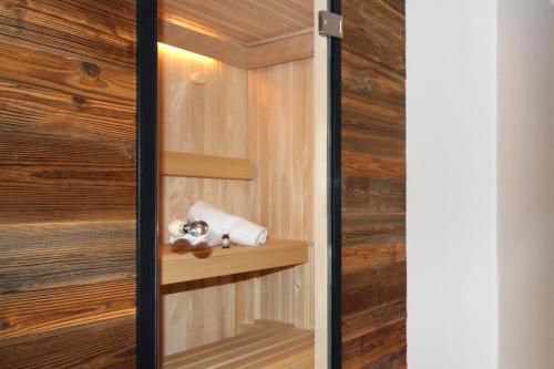 a room with wooden walls and a closet with wooden shelves at Bergzauber Alpin Suites - Skipiste - Private Sauna in Bolsterlang
