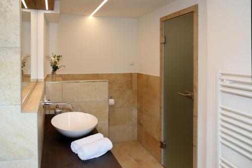 a bathroom with a sink and a toilet in a room at Bergzauber Alpin Suites - Skipiste - Private Sauna in Bolsterlang