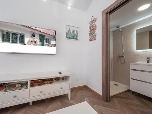 a bathroom with a sink and a mirror at La Isla , tu hogar en Torre del Mar. in Torre del Mar