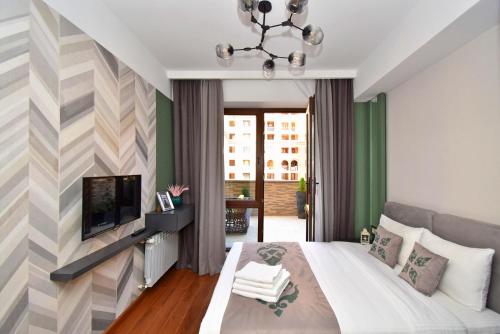 a bedroom with a large bed and a television at Yerevan4you Terrace in Yerevan
