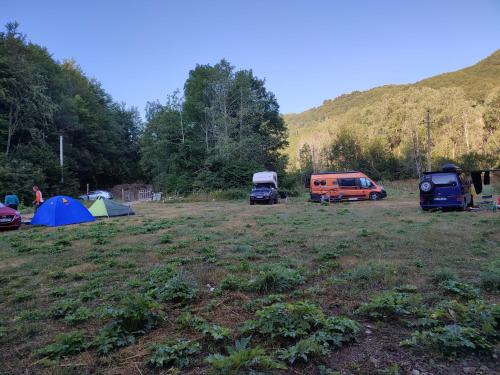 a group of tents and vehicles parked in a field at Holiday bungalows Pajkovir in Kolašin