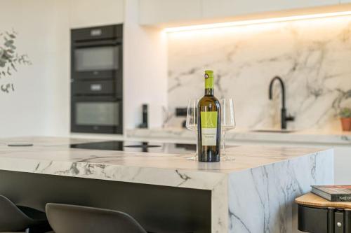 a bottle of wine sitting on a counter in a kitchen at Wellness guesthouse Passendale ***** in Zonnebeke