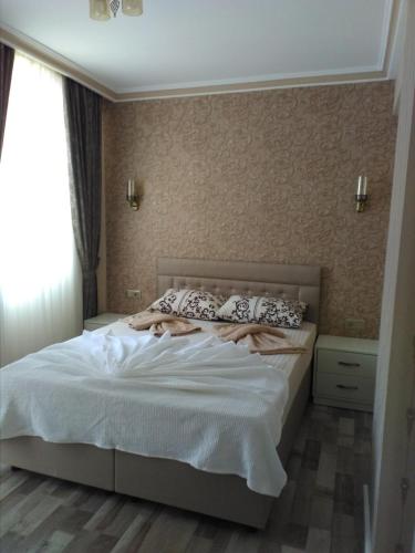 a bedroom with a bed with white sheets and pillows at Send Apart Otel in Antalya