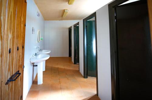 a bathroom with a sink and a toilet and a mirror at Kampaoh Cazorla in El Valle