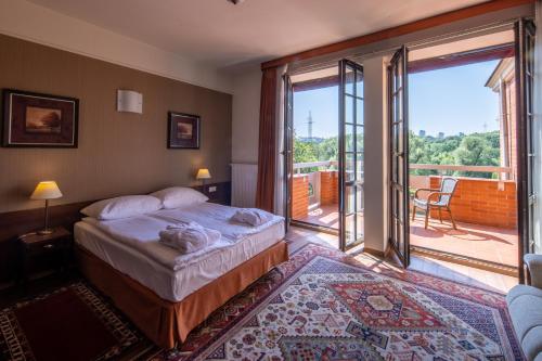 a bedroom with a bed with a view of a balcony at Hotel Słoneczny Młyn in Bydgoszcz