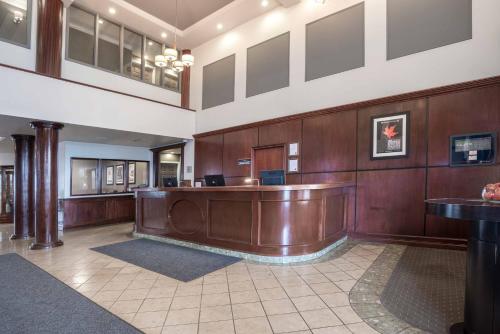 a lobby with a reception desk in a building at Sandman Hotel Saskatoon in Saskatoon