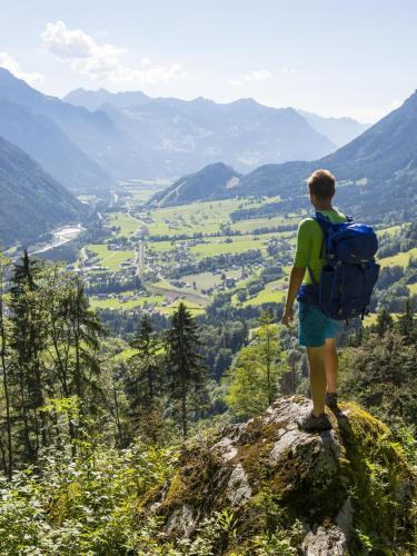 a man with a backpack standing on top of a mountain at Burtscherhof in Braz in Ausserbraz