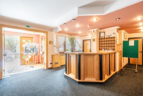 a room with a kitchen with a counter and a window at Hotel Alpina in Madonna di Campiglio