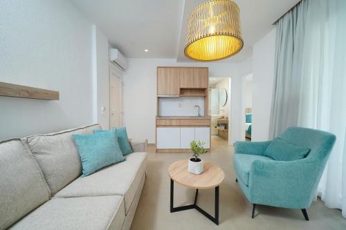 a living room with a couch and two chairs and a table at Sentimento Sea Breeze in Skala Prinou