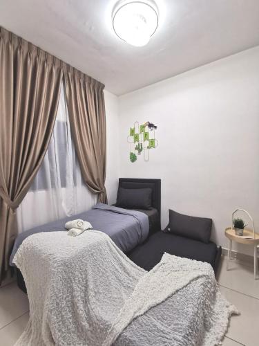 a bedroom with two beds and a window at Traders Garden in Cheras
