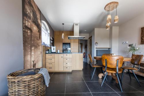 a kitchen and dining room with a table and chairs at Relax B&B Lavendine Pure in Genk