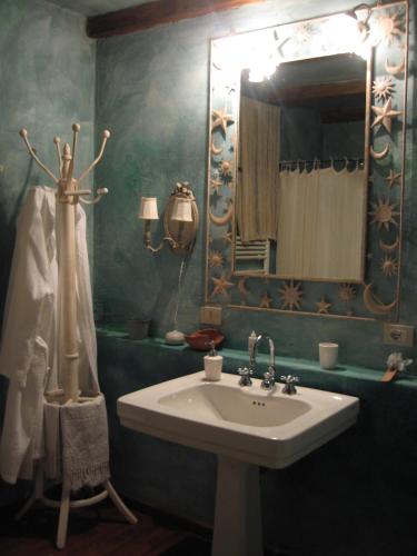 a bathroom with a sink and a mirror at Locanda dei Melograni in Gossolengo