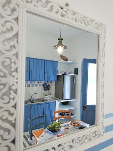 a mirror reflection of a kitchen with a table and a sink at ~~ Sea Breeze covered house ~~ in Mochlos