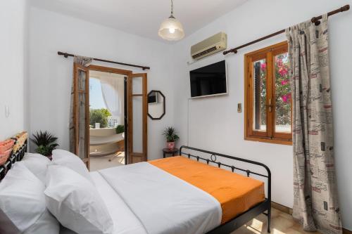 a bedroom with a bed and a bathroom at Grandpa's Yard in Adamas